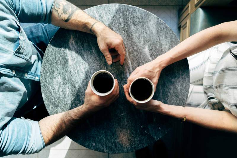 man and woman chatting over a coffee