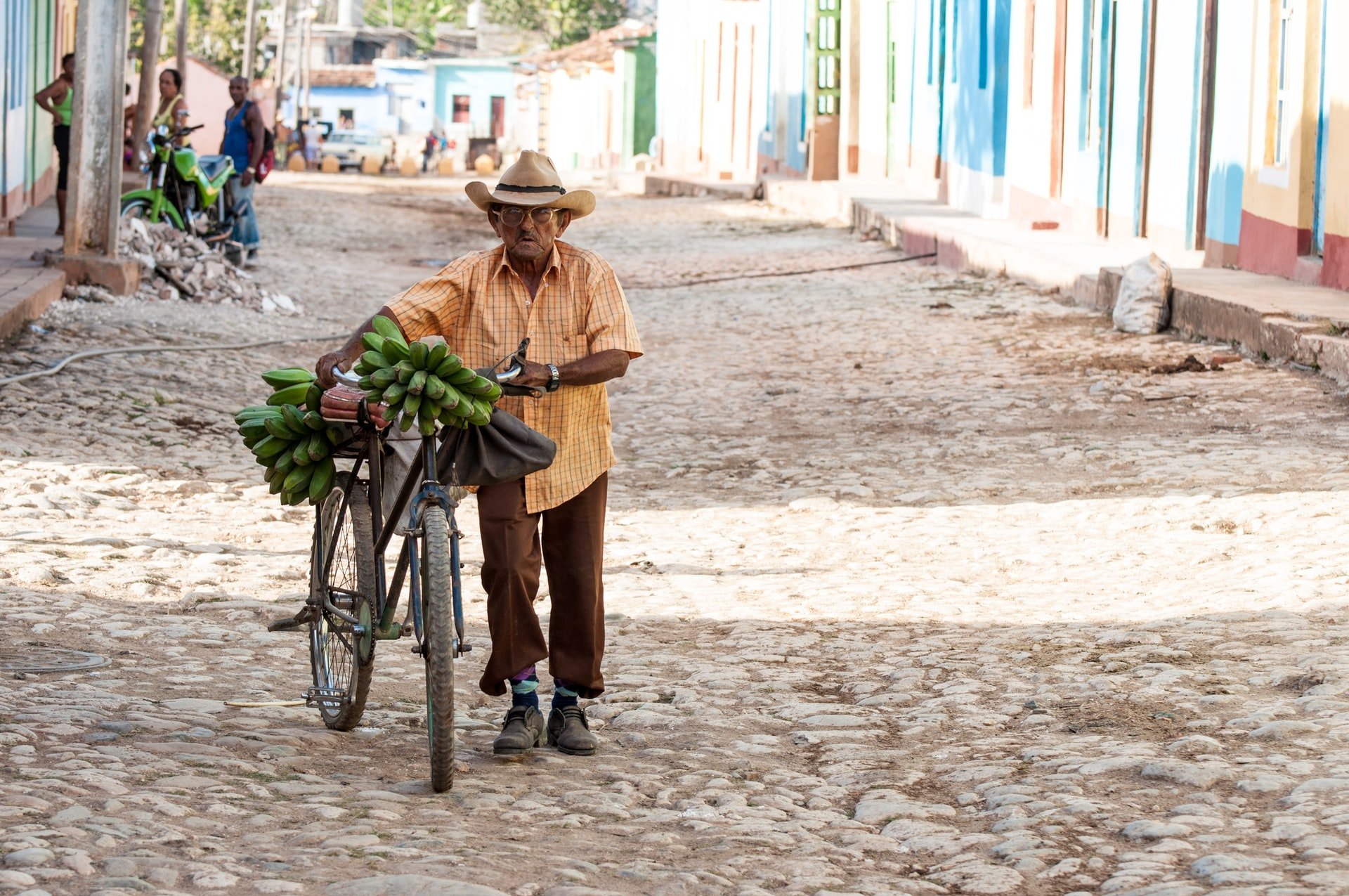 cuban man with a bicycle and bananas