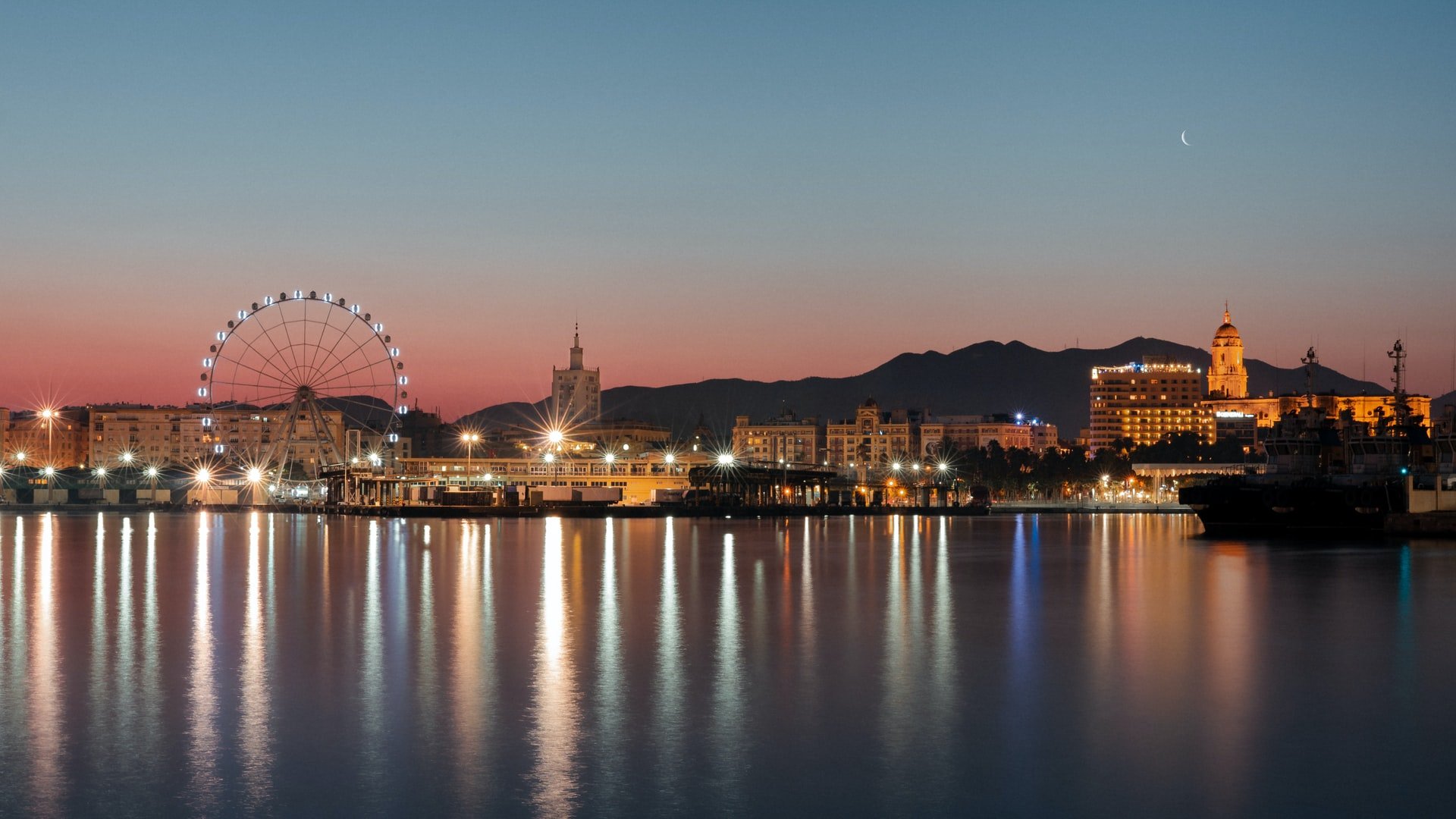 a ferris wheel next to a body of water