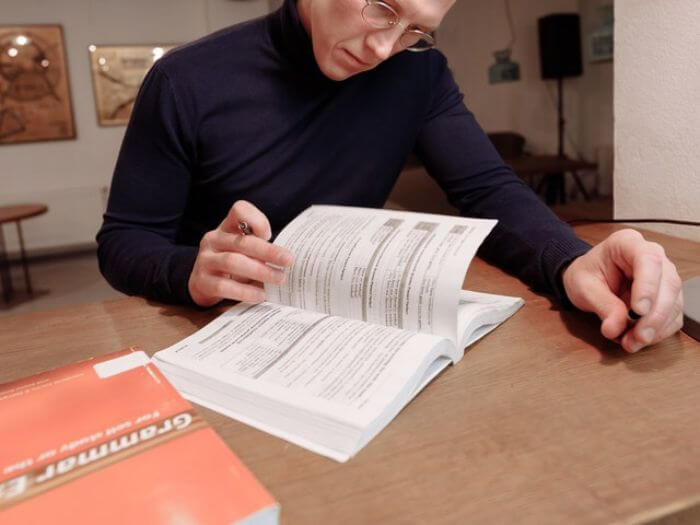 Man planning an English lesson with book