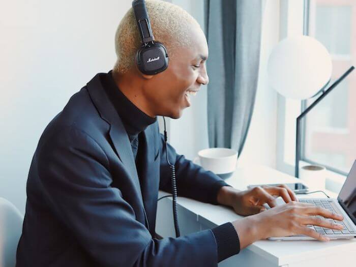 Smiling man with headset teaching English online