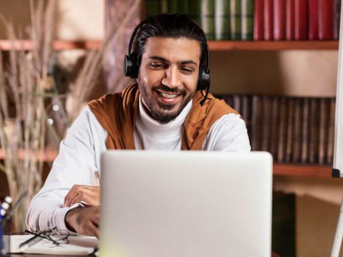 man with headset teaching online from home