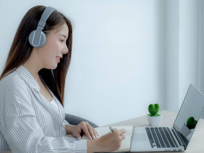 woman with headphones studying online