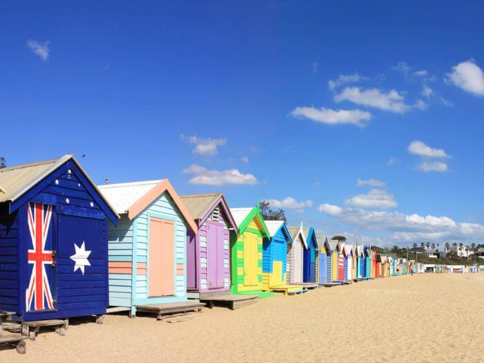 a row of colorful huts on a beach, Oz