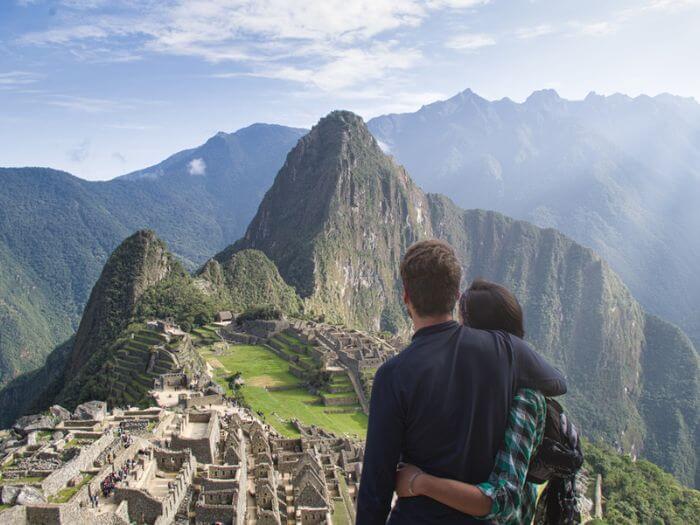 Couple looking out over Machu Picchu, Peru