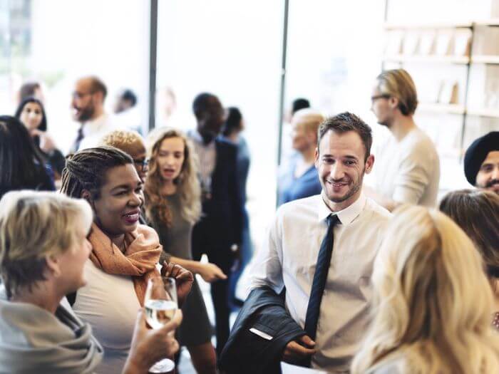 Group of people chatting during break at a conference