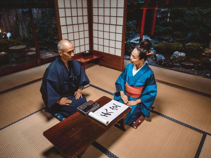 Japanese couple writing Japanese kanji