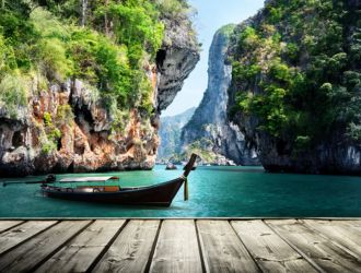Long boat and rocks on railay beach in Krabi, Thailand