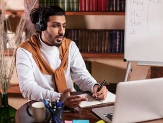 Man in headset giving an online English lesson