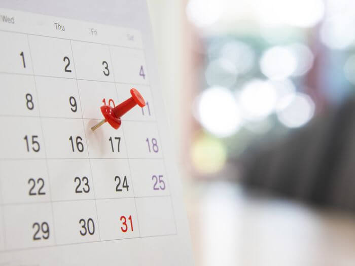 Red pin on a date in a calendar