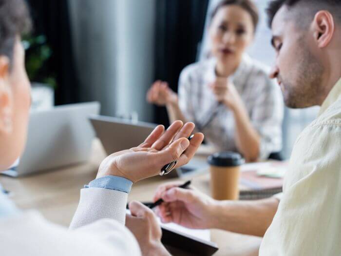 Three out of focus people in a work meeting