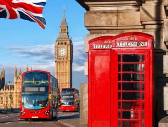 View of London with double-decker buses, Houses of Parliament and red telephone boxes